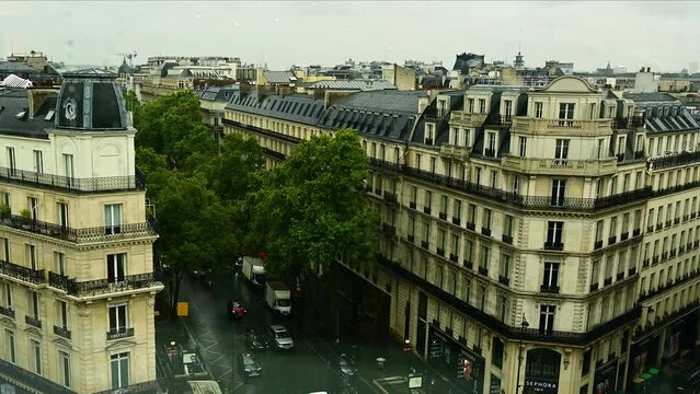 Paris, France, June 2022. View from above through a stained glass window of the old town during a rainy day. Conceptual image.