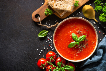 Tomato soup with ingredients on dark background. Traditional vegetable soup. Top view with copy space. - obrazy, fototapety, plakaty