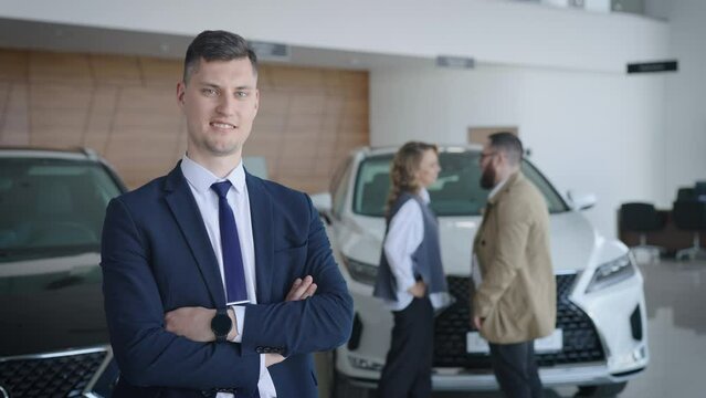 Portrait of a sales manager for new cars in the salon of an official dealer.