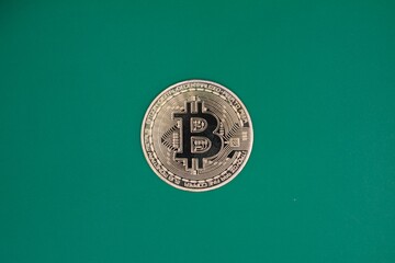 Bitcoin on a green background , concept of crypto currency