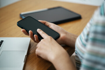 woman using a smartphone to shop online Shop in the online store through a smartphone mobile app.