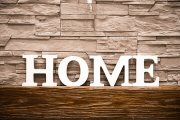 home sign over wall of tiles