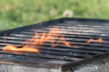 Empty barbeque on fire close up, flame on bbq
