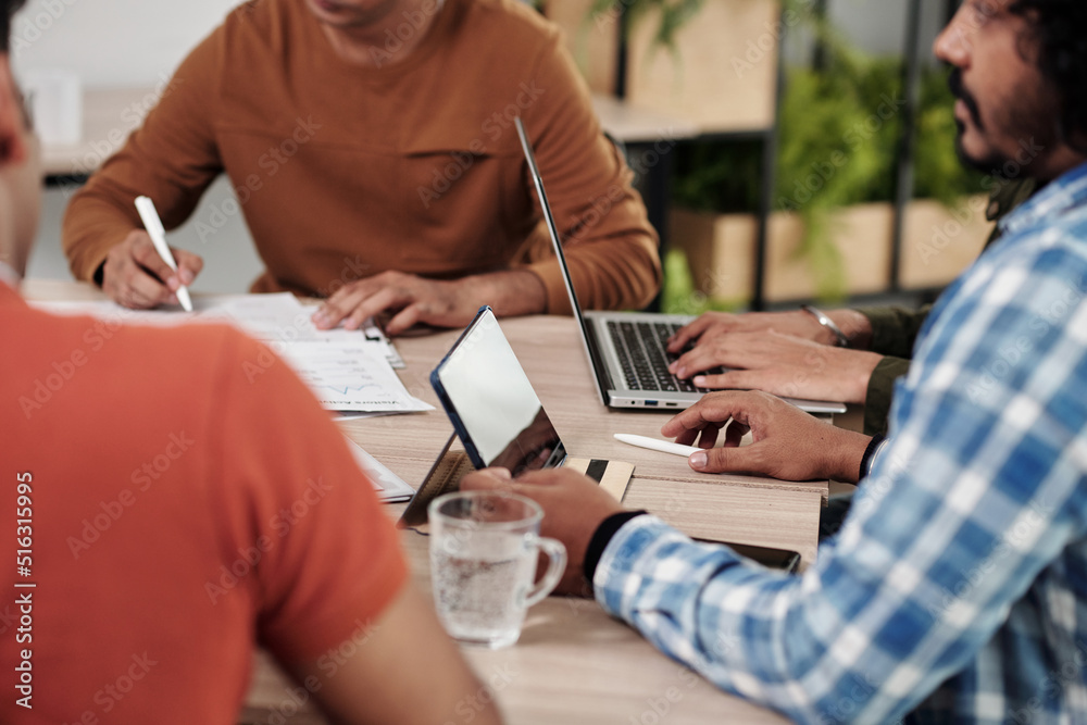 Wall mural cropped image of software development team having weekly round table discussion