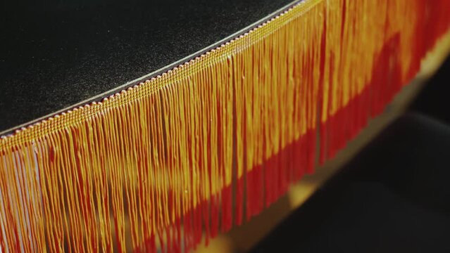 Close-up vintage style floor lamp torchere with orange fringe, slow motion.