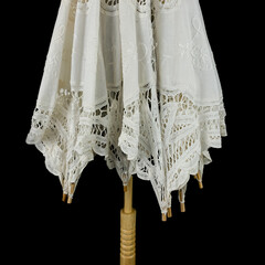 vintage white knitted umbrella. wedding umbrella on black isolated background
