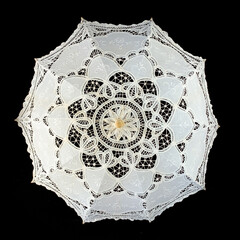 vintage white knitted umbrella. wedding umbrella on black isolated background