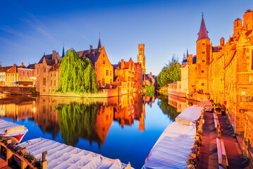 Fototapeta premium Bruges, Belgium. Rozenhoedkaai illuminated at night, old town with Belfry reflection