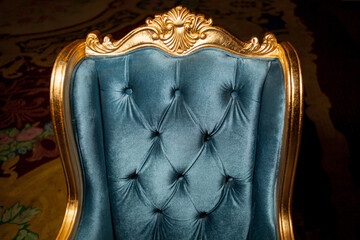 Vintage antique chair with gold. Concept of luxury and success with gold velvet and gold armchair....