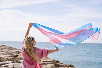 Young woman with trans flag