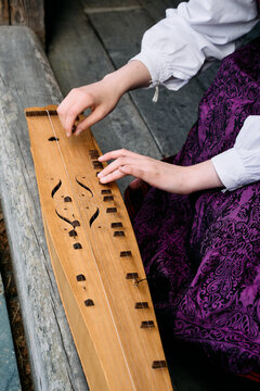 Plying on the Norwegian traditional string instrument "langeleik".