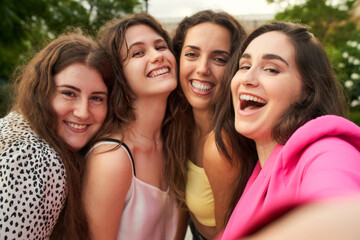 Fototapeta premium a group of four friends having fun and taking pictures of each other