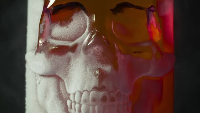 Red Glass Skull in Frost. A glass vessel with a bright, rich red content in the form of a glass skull, cooled by liquid evaporating nitrogen
