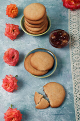 Fototapeta na wymiar Still life of biscuits, jam, lace and roses