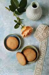 Homemade cookies on a turquoise background. Rose and lace. Toning