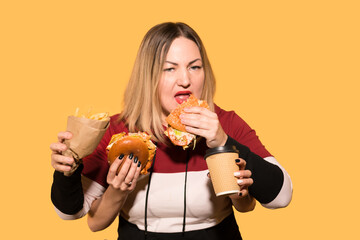 Woman with four hands eating fast food.