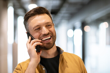 Smiling Business Man Talking On Phone Communicating At Workplace