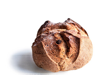 Round bread close-up on white background. Freshly baked sourdough bread with a golden crust. Baker shop context with delicious bread.