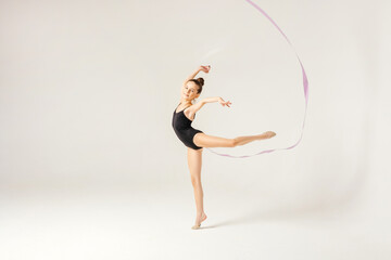 Obraz na płótnie Canvas Girl gymnast performs a jump to the top.