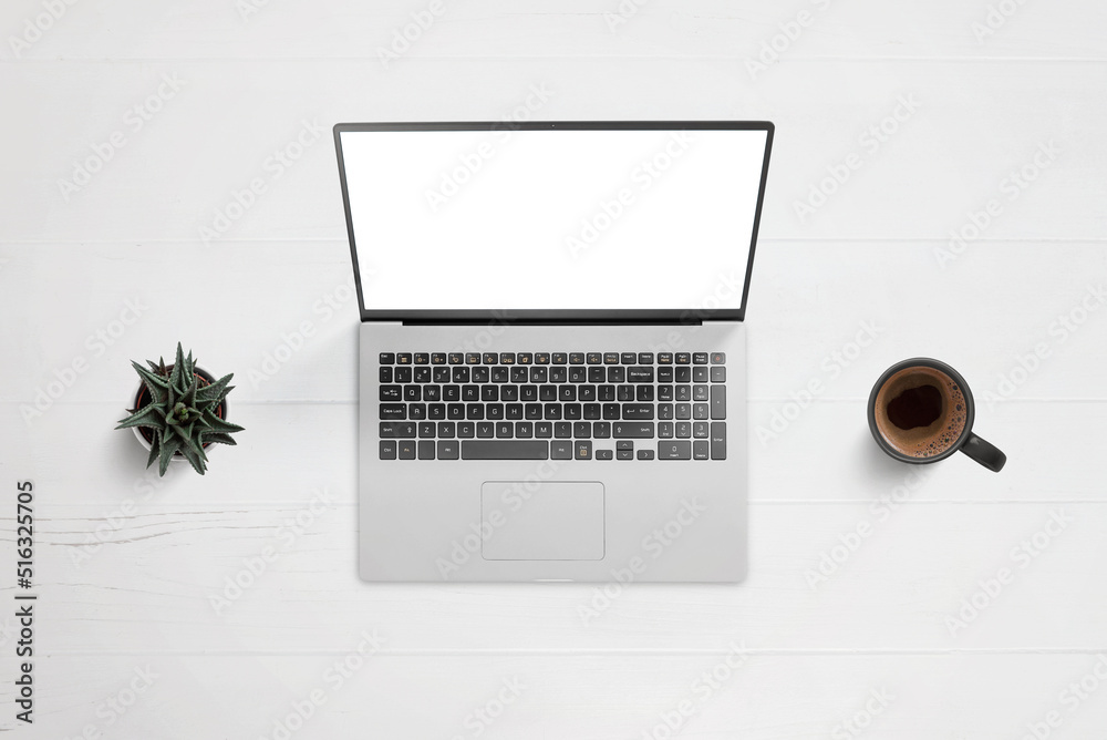 Aufkleber Laptop on work desk with isolated screen for app or web page design showcase. Top view, flat lay composition with plant and coffee mug beside