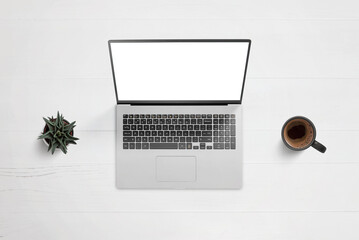 Laptop on work desk with isolated screen for app or web page design showcase. Top view, flat lay composition with plant and coffee mug beside