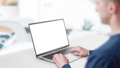 Mockup image of a man working at the laptop. Clean desk with office interior in background. Isolated screen in white for web page promotion
