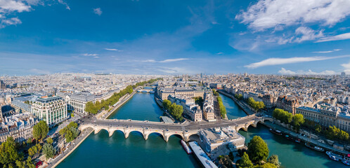 Paris aerial panorama with river Seine, Pont Neuf bridge, ile de la cite and Notre-Dame church, France. Holidays vacation destination. Panoramic view above historical Parisian buildings and landmarks. - obrazy, fototapety, plakaty