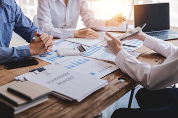 Young colleagues having great business conversations in a modern coworking office. Teamwork concept. Horizontal blurry background. Fireworks.