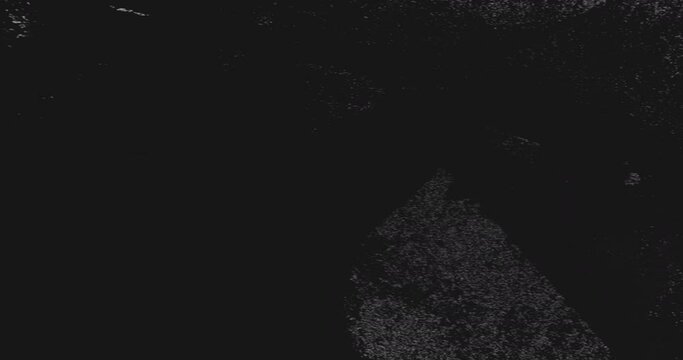 Grunge texture background. Grain noise. Messy effect for intro. Black white ink stain splatter on dark uneven rough abstract surface.