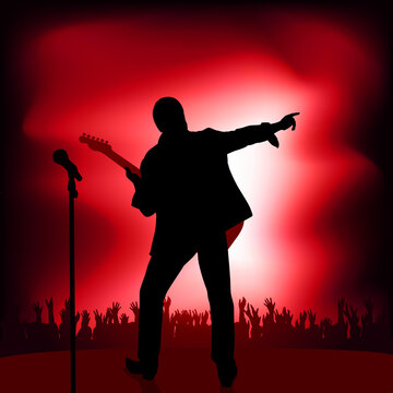 Concept of the rock music concert with a guitarist who greets his audience by pointing the finger at the crowd who applaud his show.