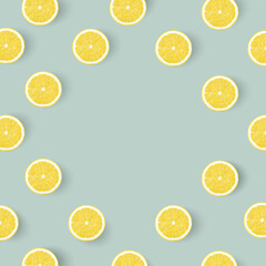 Creative summer pattern made of lemon slices on pastel blue background. Fruit minimal concept. Flat lay. Fruit frame. Yellow lemons on blue pastel table. Top view. Space for text