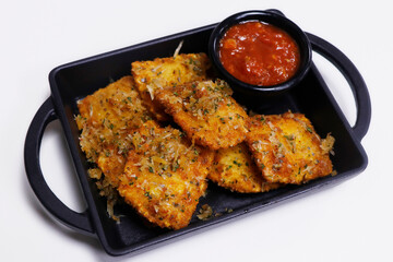 crispy fried cheese filled pasta ravioli with tomato marinara sauce in a plate