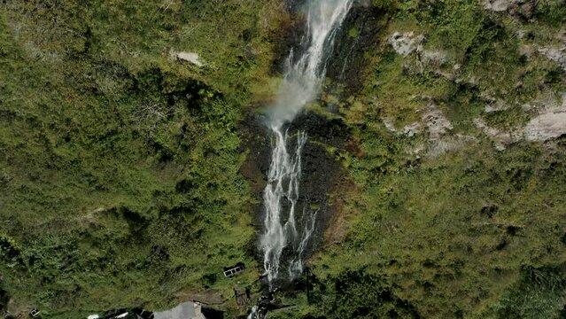 Cascada Manto de la Novia With Water Cascading On Lush Mountains In Baños de Agua Santa, Ecuador - aerial drone shot