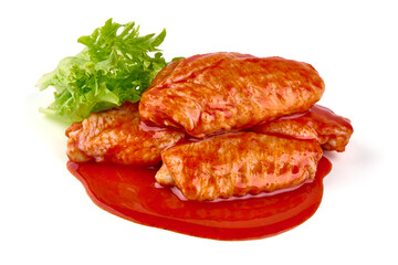 Marinated Buffalo chicken wings in red sauce with lettuce salad leaf, isolated on white background.