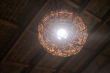 Low angle view of a chandelier on a ceiling in a dark room - Powered by Adobe