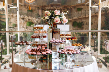 Served festive candy bar table with cupcakes and other desserts