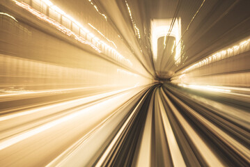 Motion blurred of train moving inside tunnel with daylight in tokyo, Japan. yollow color background concept