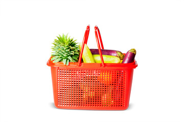 Red plastic basket with fresh vegetables in studio
