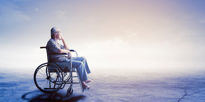 Sad senior man sitting in the wheelchair