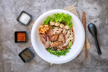 Pork Noodle Soup with seasoning From Top Angle View on Grey Table.