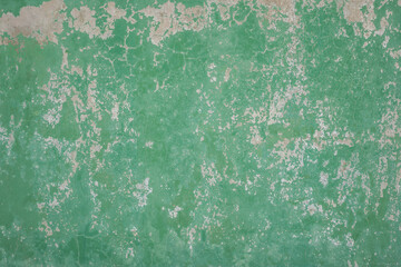 Green cement wall texture with peeling paint on the surface. For texture and background