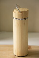 Vertical shot of a water bottle made out of bamboo on the counter