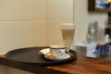 Cappuccino with sugar on a tray