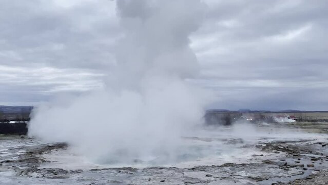 An Iceland water spout geyser bubbles and then does a small eruption.