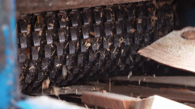 Wood chipper, strong iron teeth of a special press grind wood and turn it into sawdust