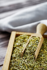 fragrant dried rosemary on a wooden rustic background