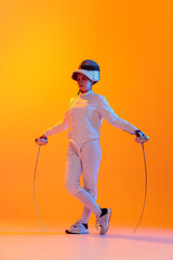 Studio shot of professional fencer in white fencing costume and mask in action, motion isolated on...