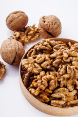 dried walnuts on a white acrylic background