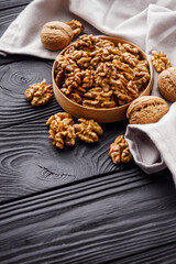 dried walnuts on a black rustic wooden background