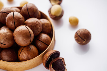 fresh macadamia nuts on a white acrylic background